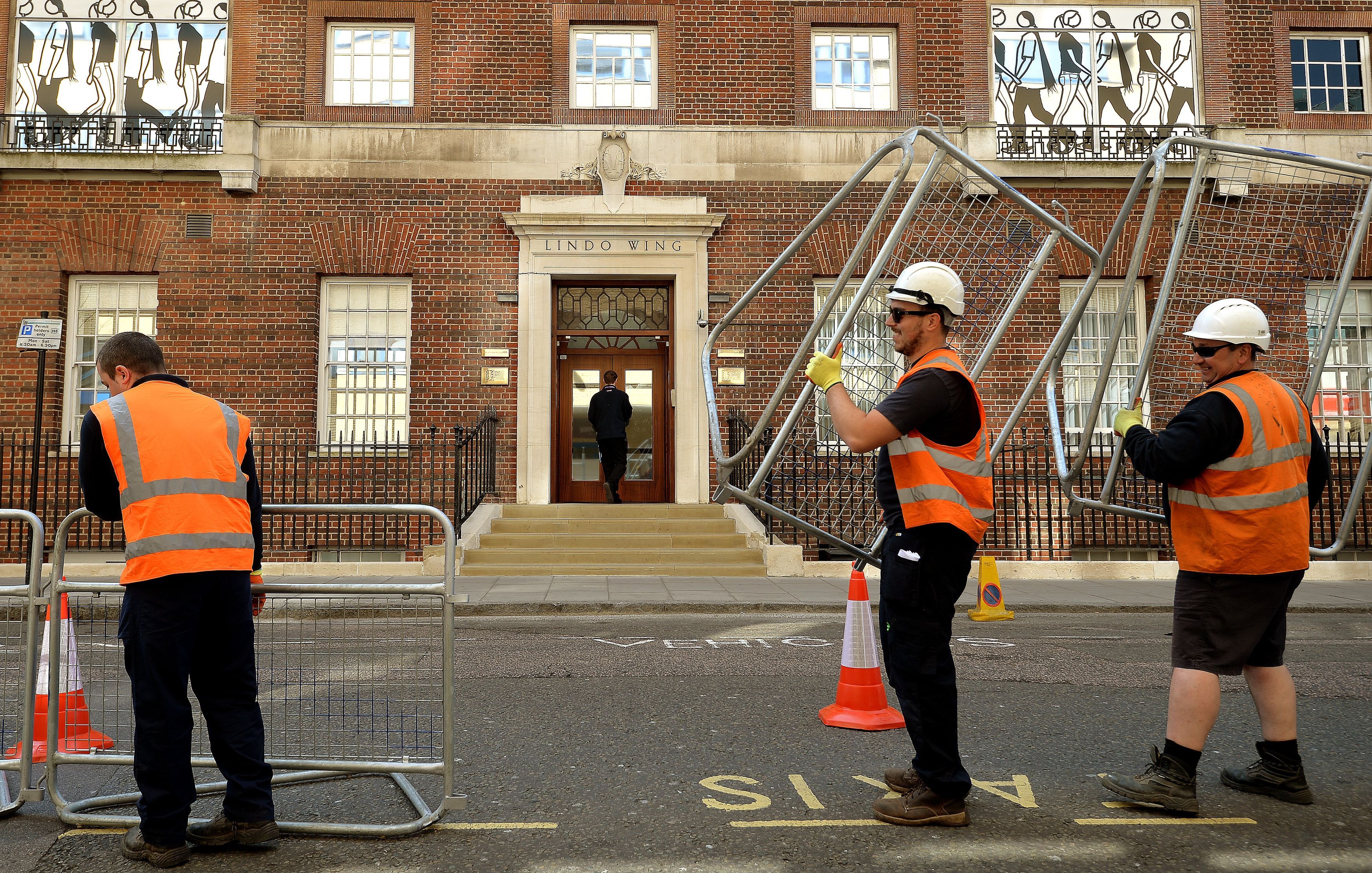 Men set up barriers for the second royal baby