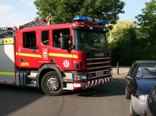 A fire engine struggles to get along a road