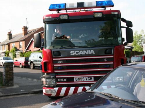 A fire engine struggles to get along a road
