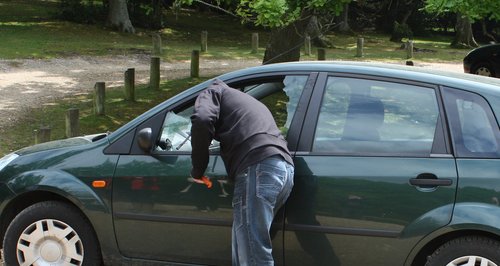 man reconstructing breaking into a vehicle