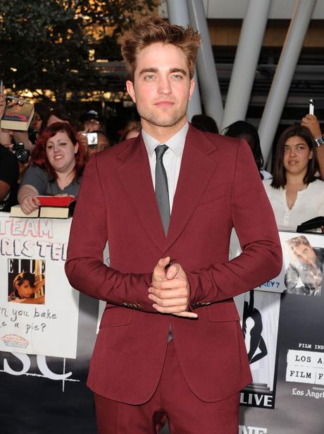The dashing Robert Pattinson wears a maroon suit at a premiere