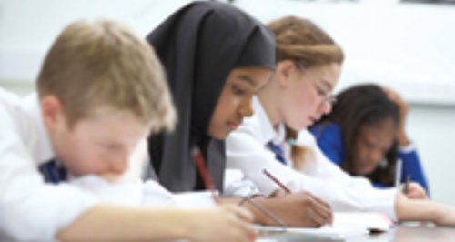 Pupils working at desks in school