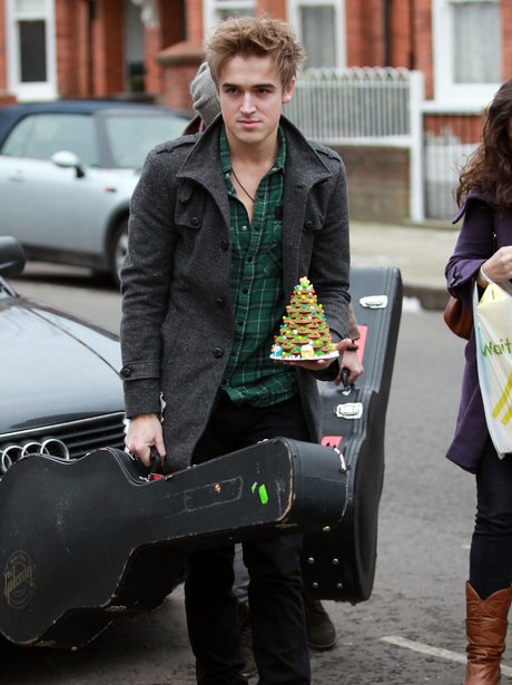 Tom Fletcher carrying a guitar case