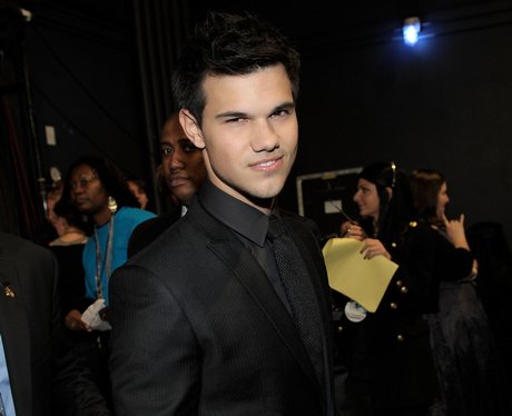Taylor Lautner looks handsome in a black suit