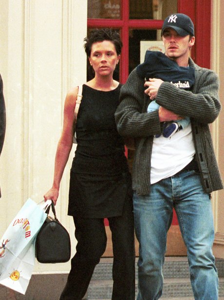 Victoria and David Beckham holding baby Brooklyn