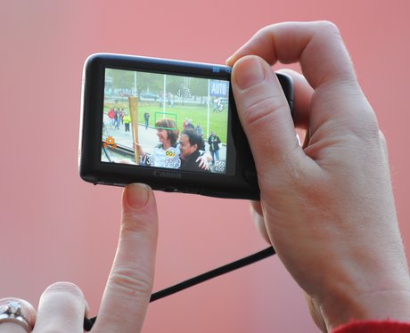 Crowds snap the Olympic Torch