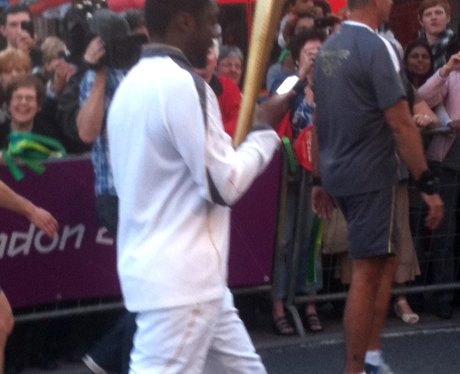 Will.i.am carries the Olympic Torch