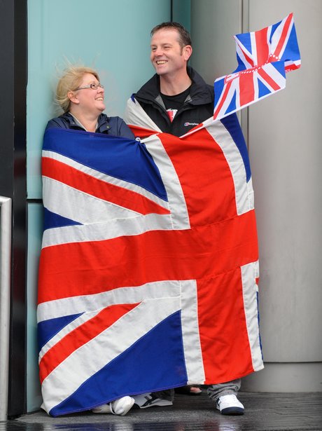 A couple wear the flag with pride