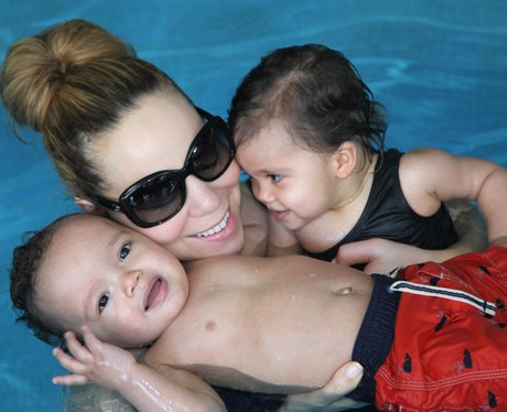 Mariah Carey and children playing in a swimming pool