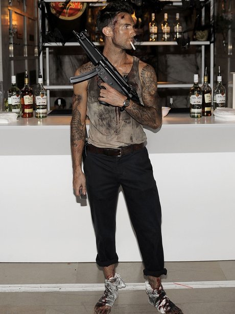 Adam Levine posing as rambo for halloween