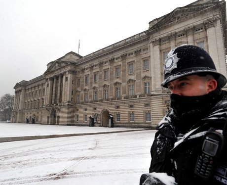 A policeman in the snow outside Buckingham Palace