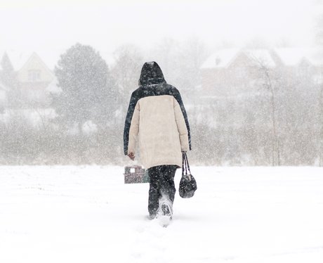 A woman walking through a snow storm