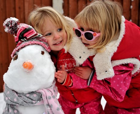 Two girls and their snowman