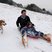 Image 3: A father and son with their dog on a sledge 
