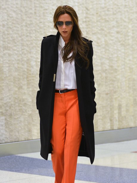 Victoria Beckham in orange trousers