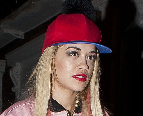 Rita Ora wearing a red cap