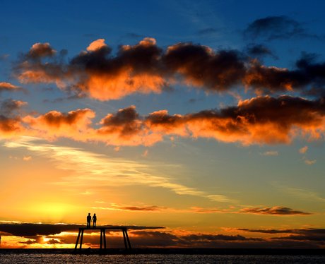 The sun rises over a sculpture in Northumberland.