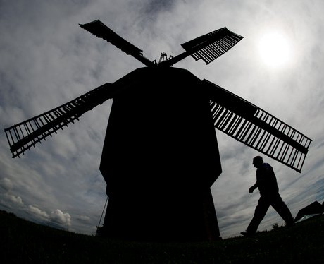 A man walks past the 375 year old windmill