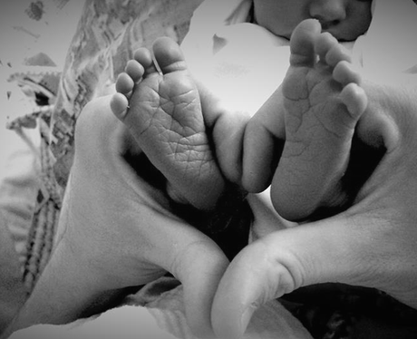 Baby feet with heart hands