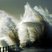 Image 5: Waves crashing against a lighthouse