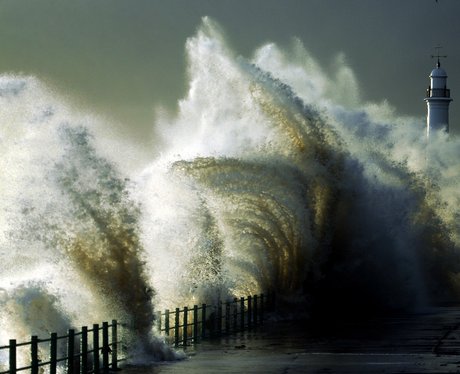 Waves crashing against a lighthouse