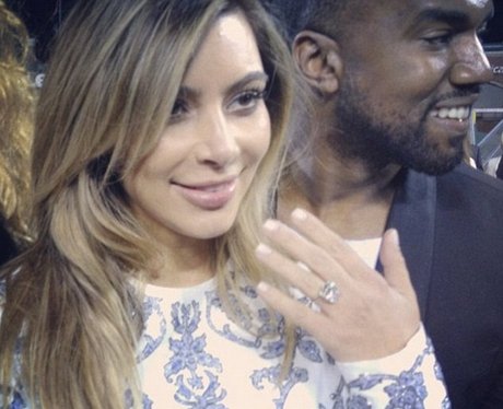 Kim Kardashian flashes her sparkling engagement ring.