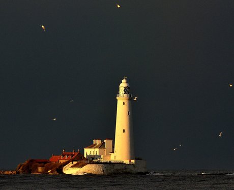 black clouds over a lighthouse