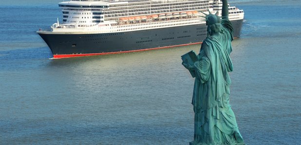 QM2 passing The Statue of Liberty