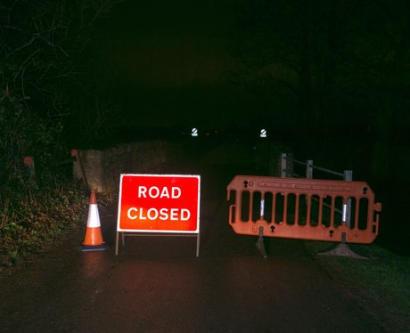 A sign blocking off a road