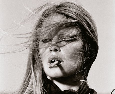 A black and white photograph by Terry O'Neill of Bridgitte Bardot with the win blowing in her face