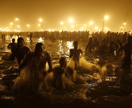 People gathered in a lake surrounded by candles