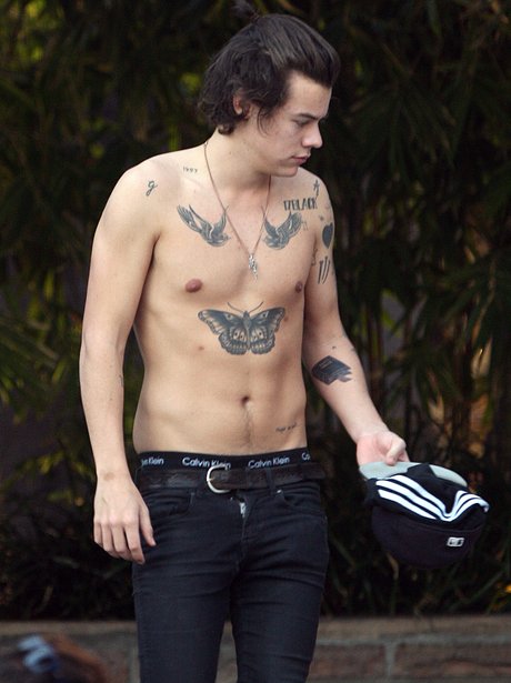 Harry Styles topless showing off new bible tattoo