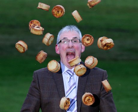 A man throwing pies in the air