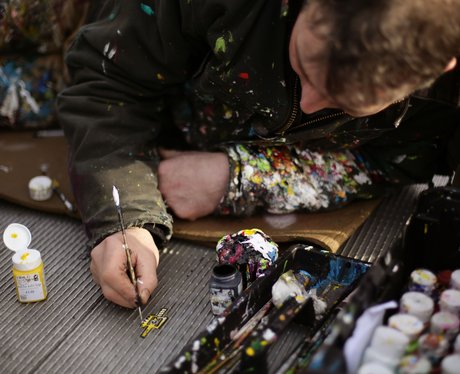 A man creating a miniature piece of art out of gum