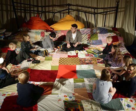 children sitting on giant bed