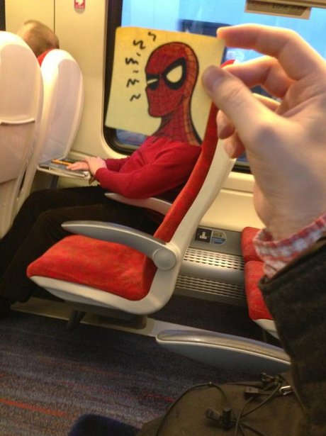 Spiderman postit on man on train.