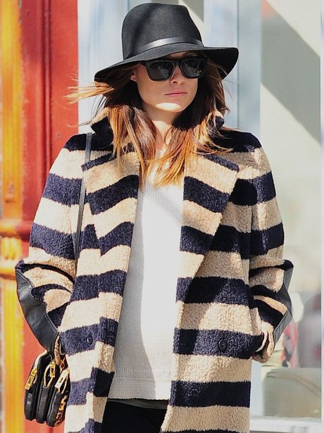 Olivia Wilde in a hat and stripy cardigan