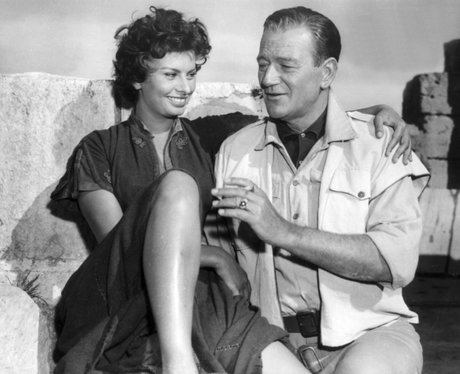 Sophia Loren and John Wayne laughing