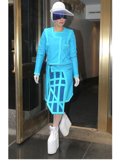 Lady Gaga in white platform shoes and a blue top a