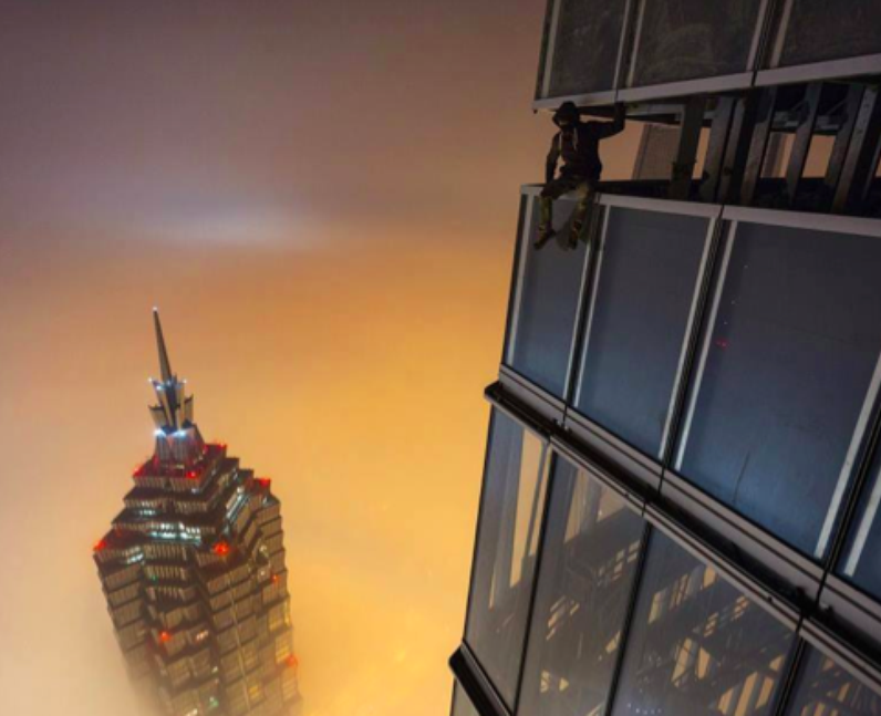 A man sitting above the Shanhai skyline