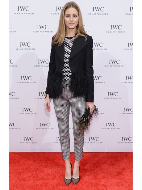 Olivia Palmero on the red carpet in a feathered jacket