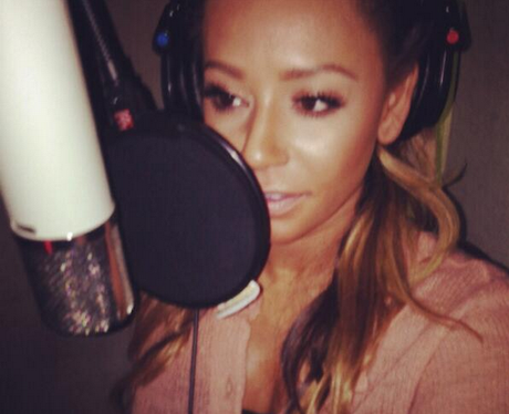 Mel B singing into a mic