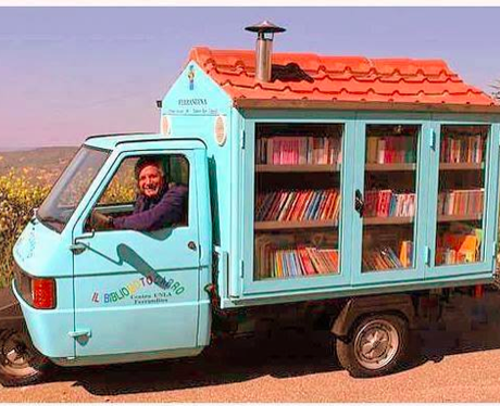 A man driving a car full of books