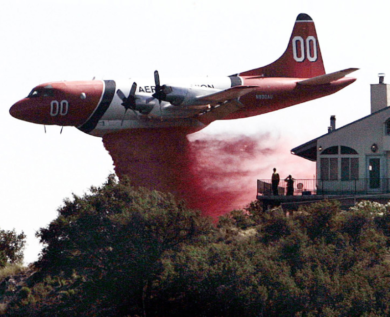 A plane releasing red water