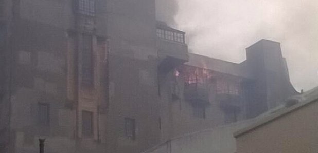 Flames can be seen coming from the roof.