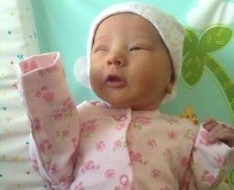 A baby pulling a funny face