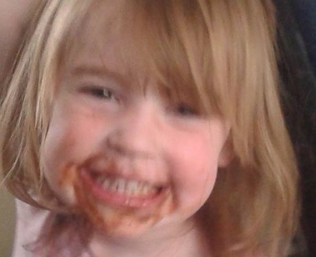 A little girl with chocolate around her mouth