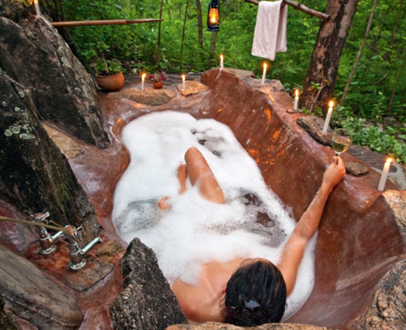A woman in a bath in a wood