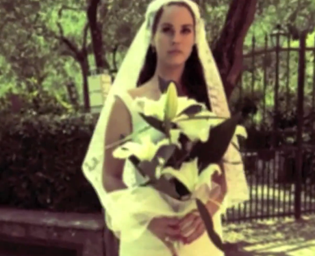 Lana Del Rey looks angelic in a lace wedding dress for her music video