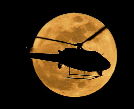 A helicopter in front of the Supermoon 
